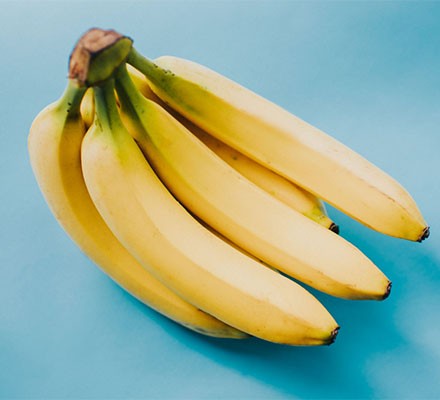 A bunch of bananas on a blue background